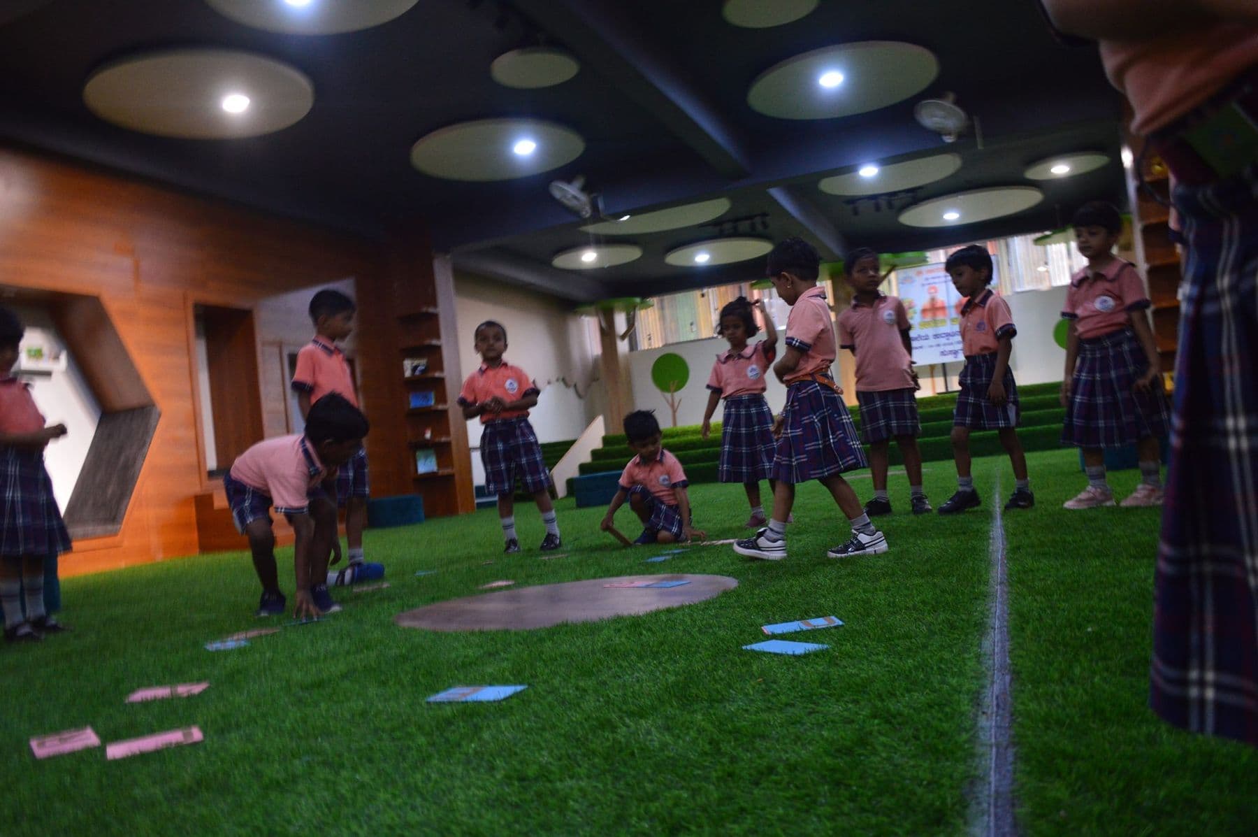Children playing a learning game in the library hall