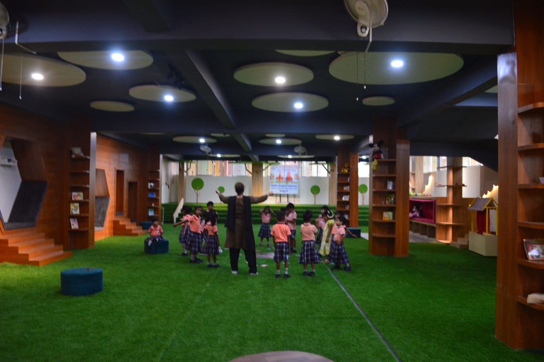 Children doing a movement activity in the library hall