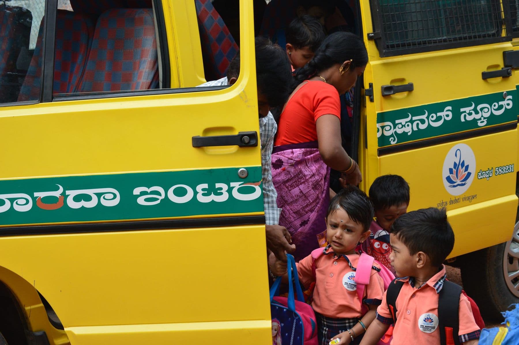 Little ones climbing out of the yellow school bus