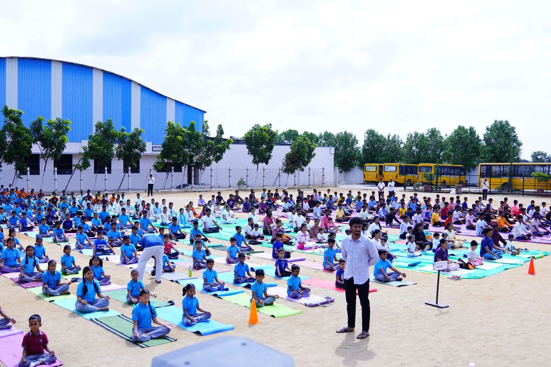 Children sitting calmly on yoga mats across the ground