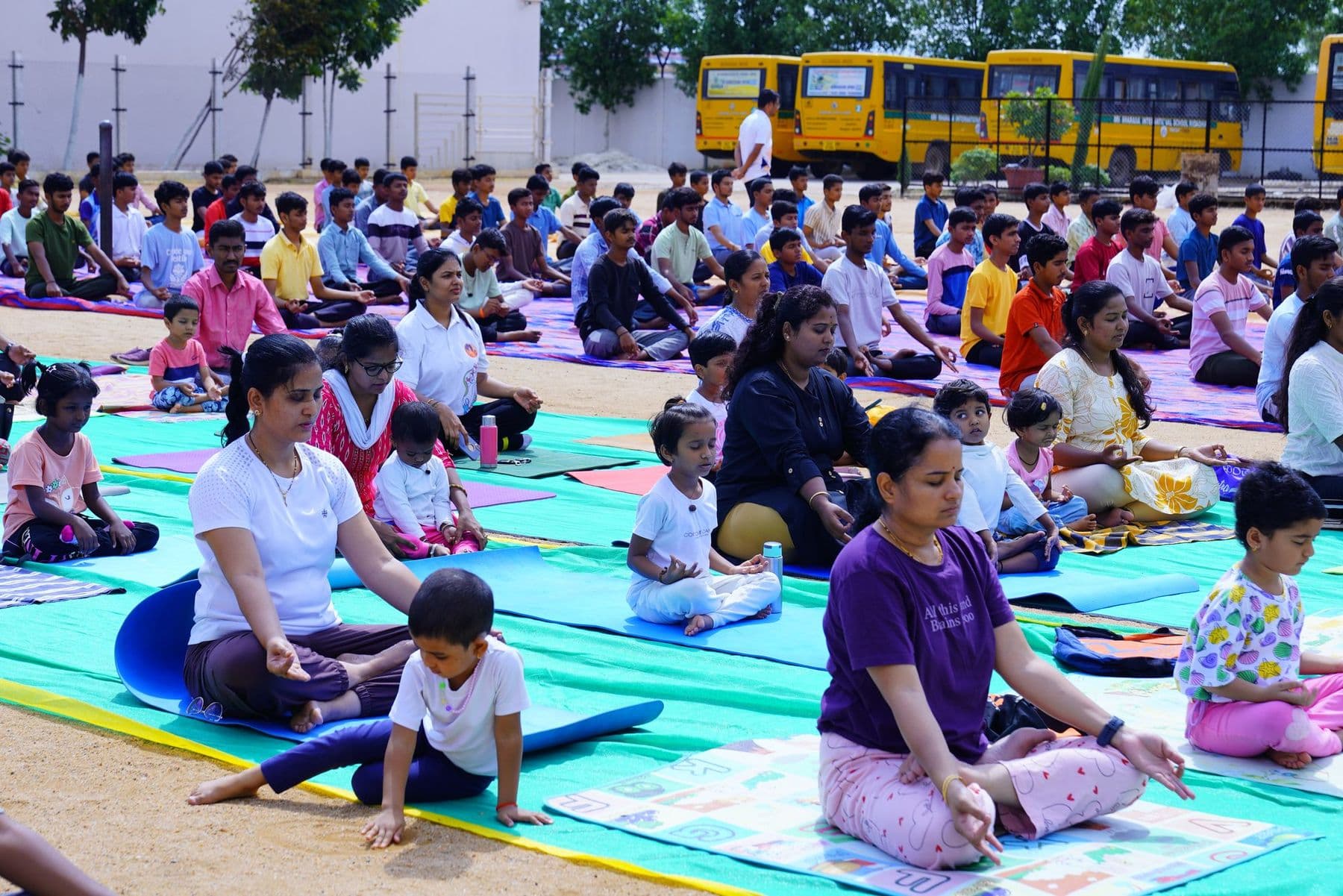 Parents and little ones doing yoga side by side