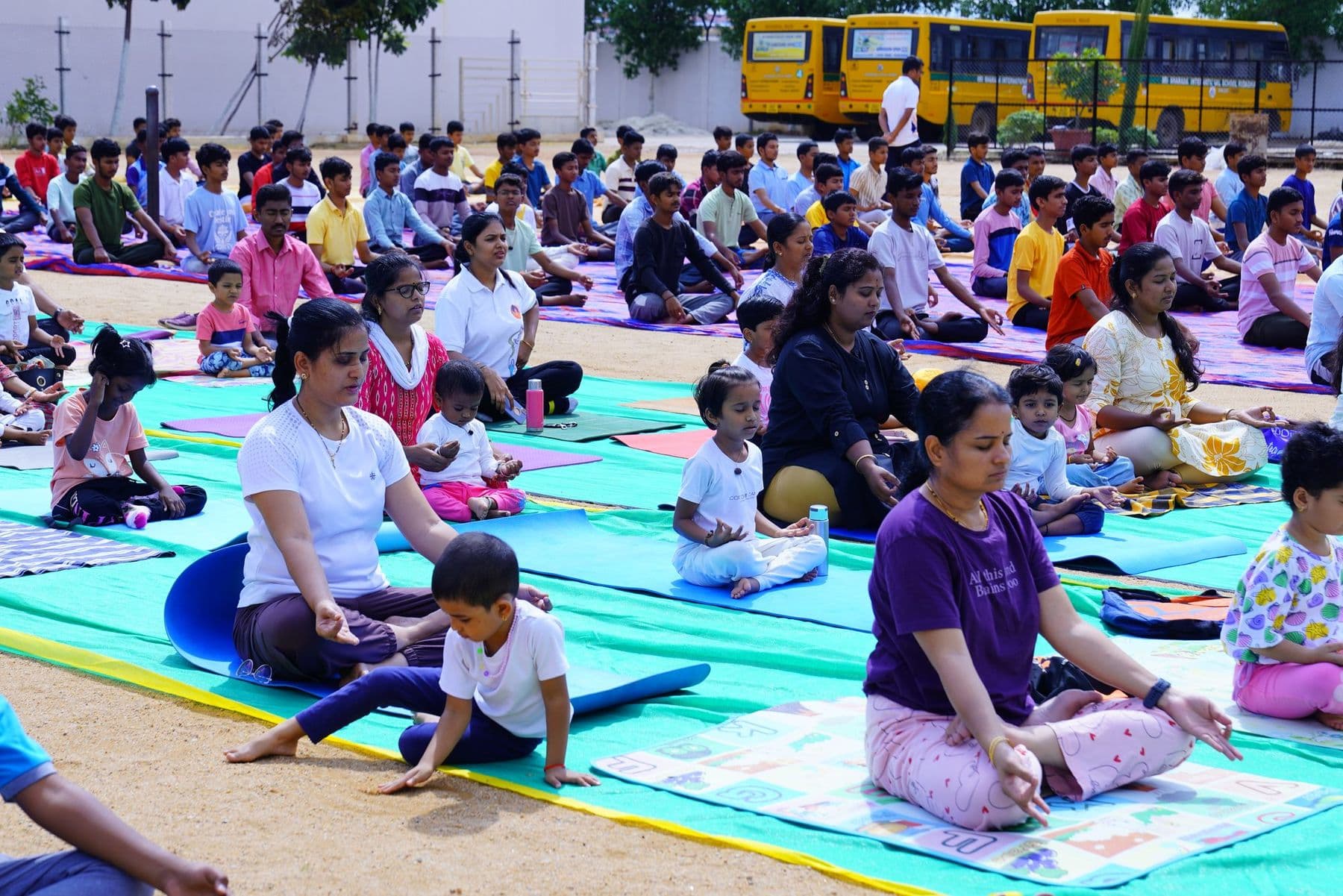 A child copying a yoga pose next to a parent