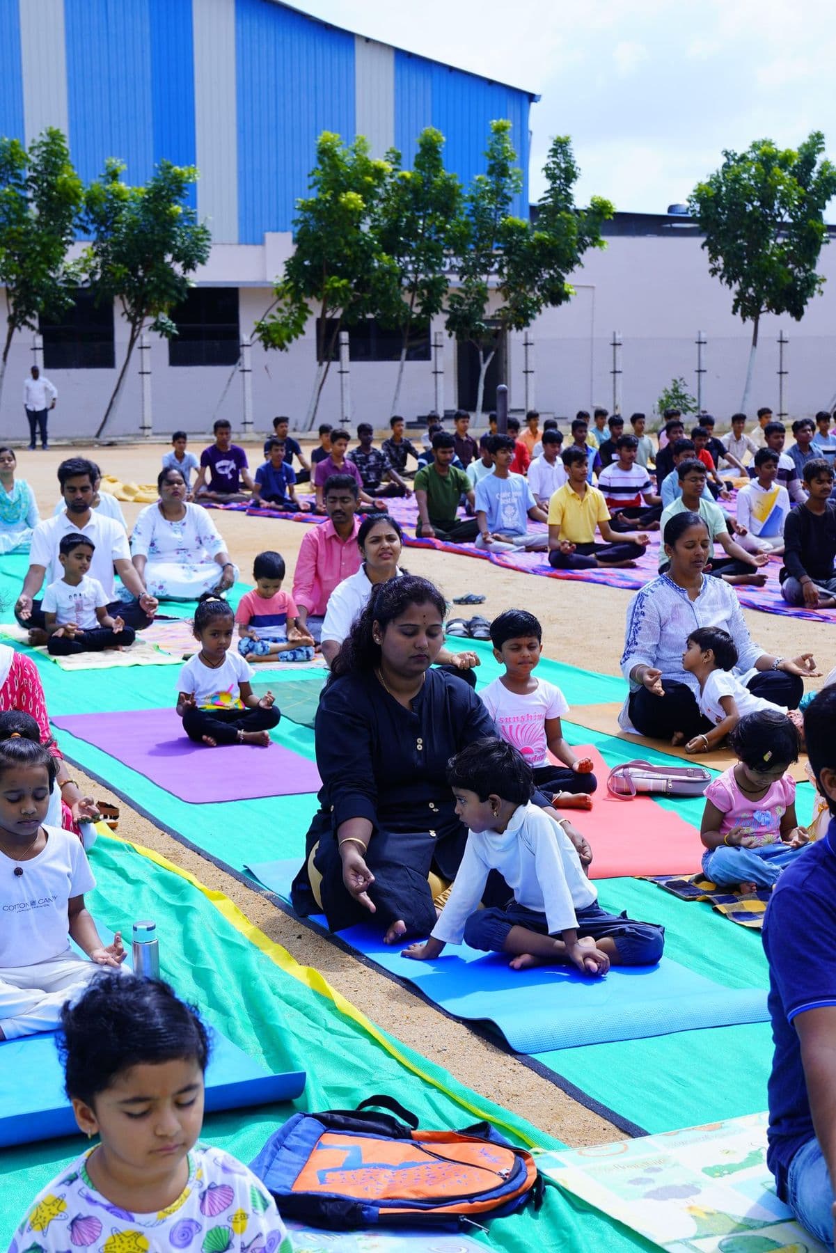 A parent and child stretching together on a yoga mat