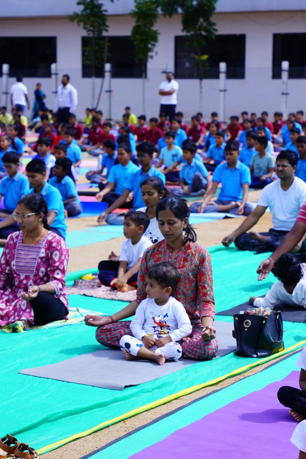 A mother and daughter sitting peacefully on their mats