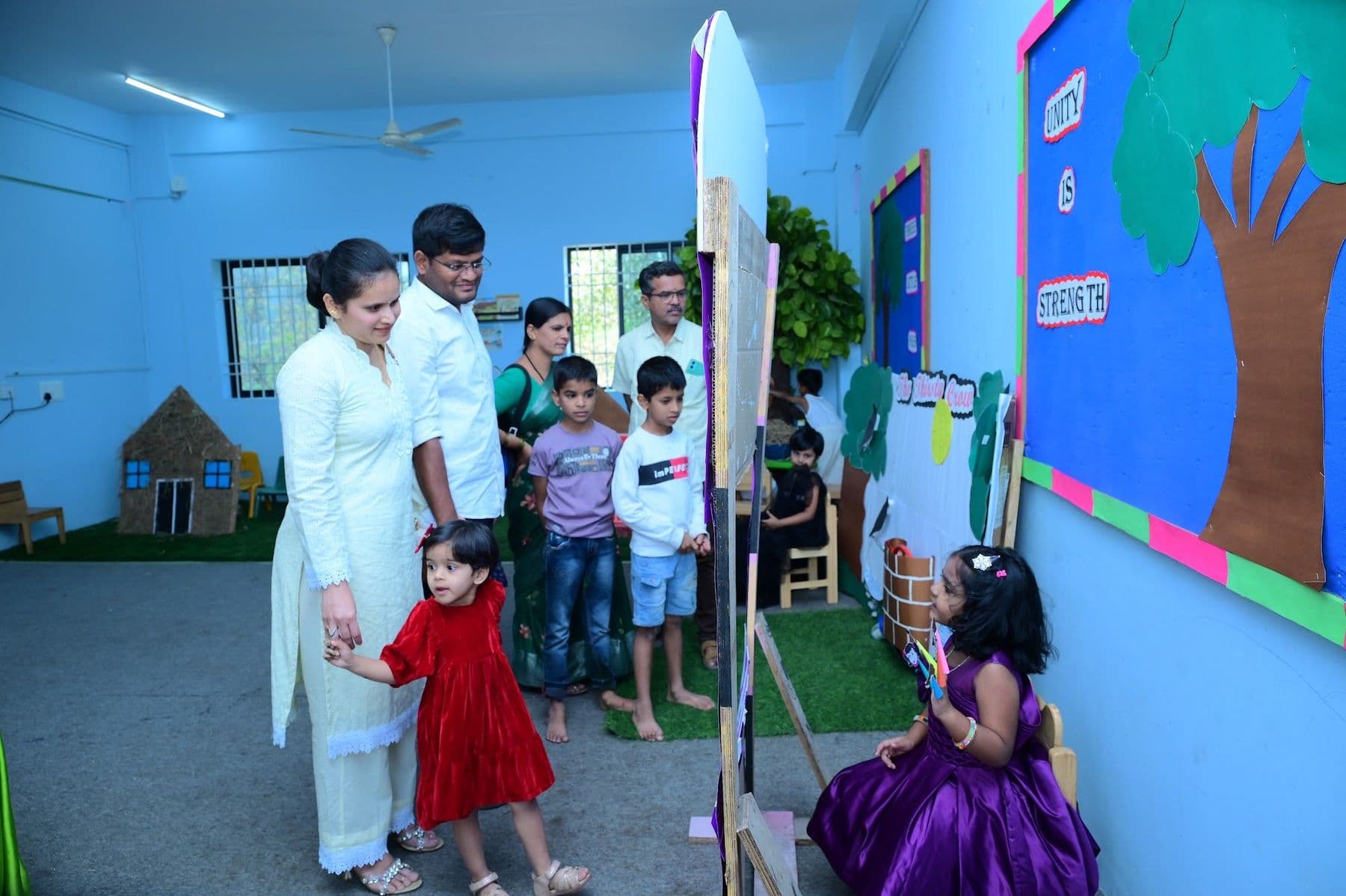 Children presenting their work to parents and guests