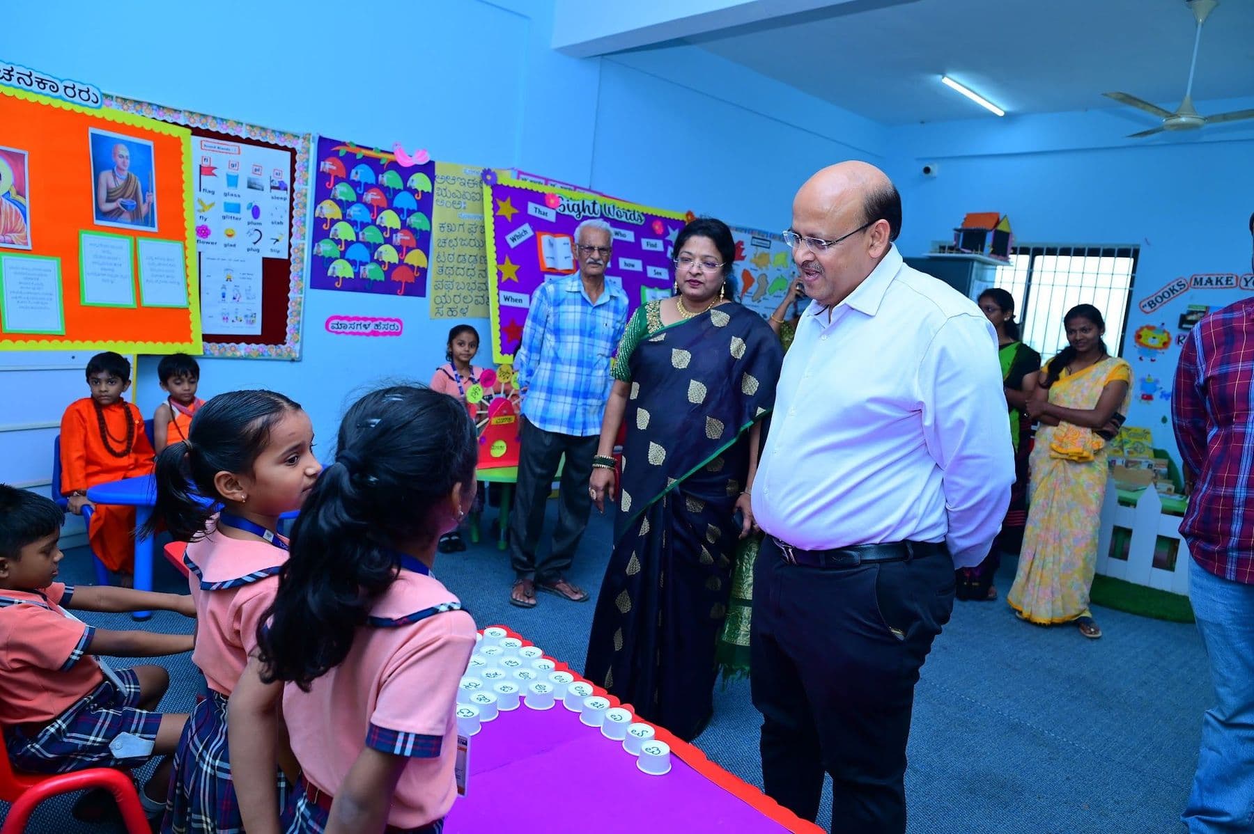 Children presenting their exhibit to a guest