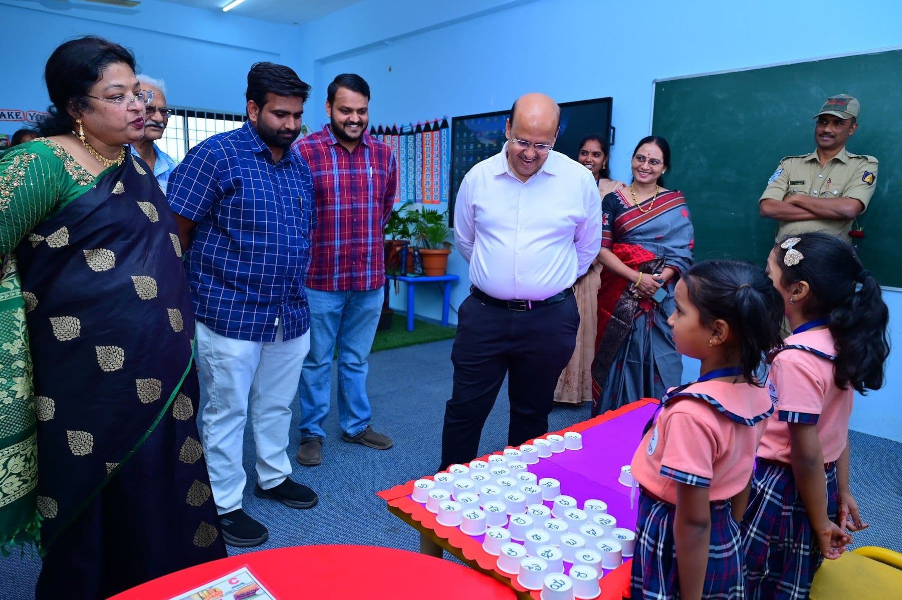 Children explaining their activity to a group of visitors