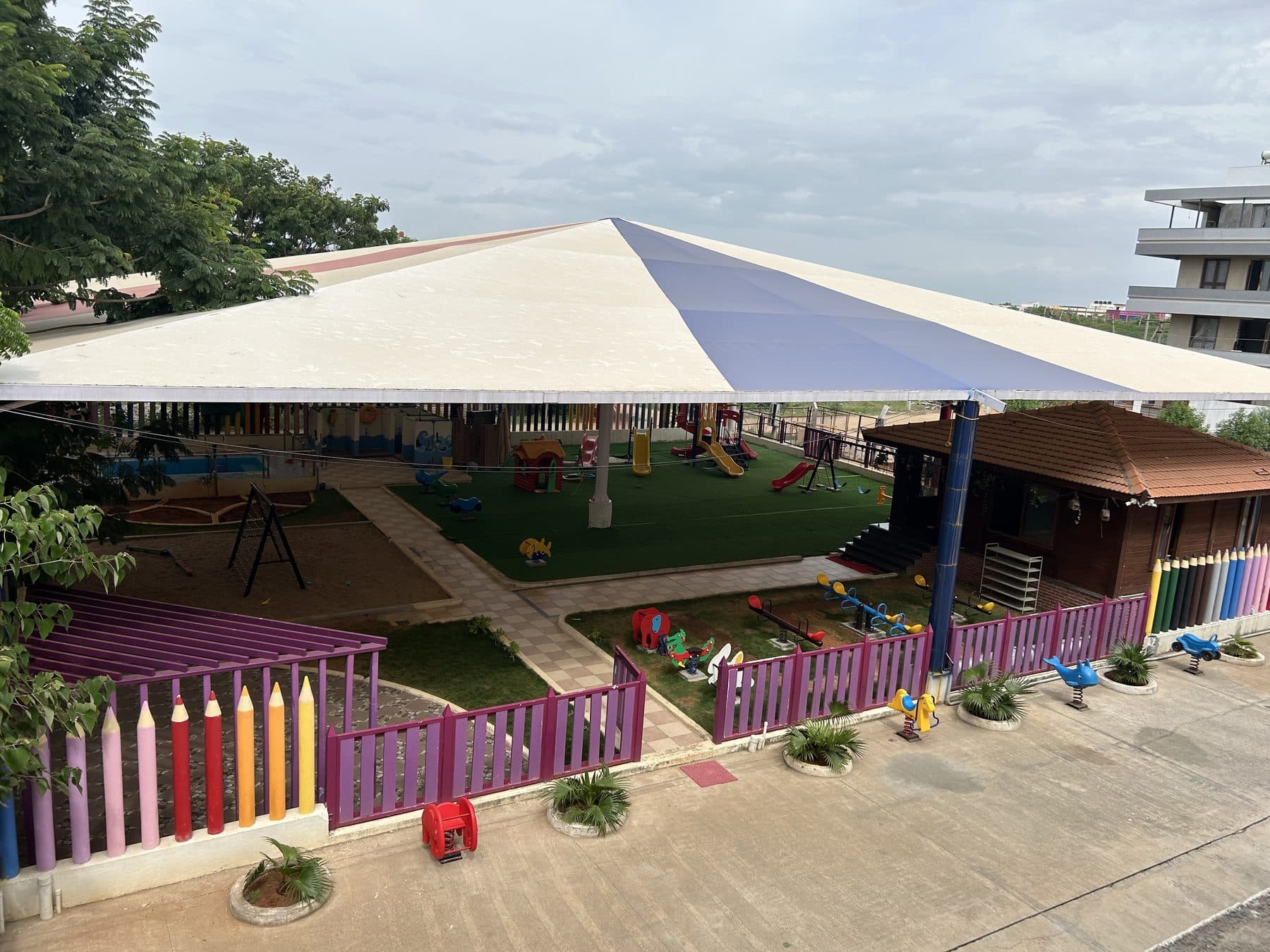 The shaded play garden with a colourful pencil fence, seen from above