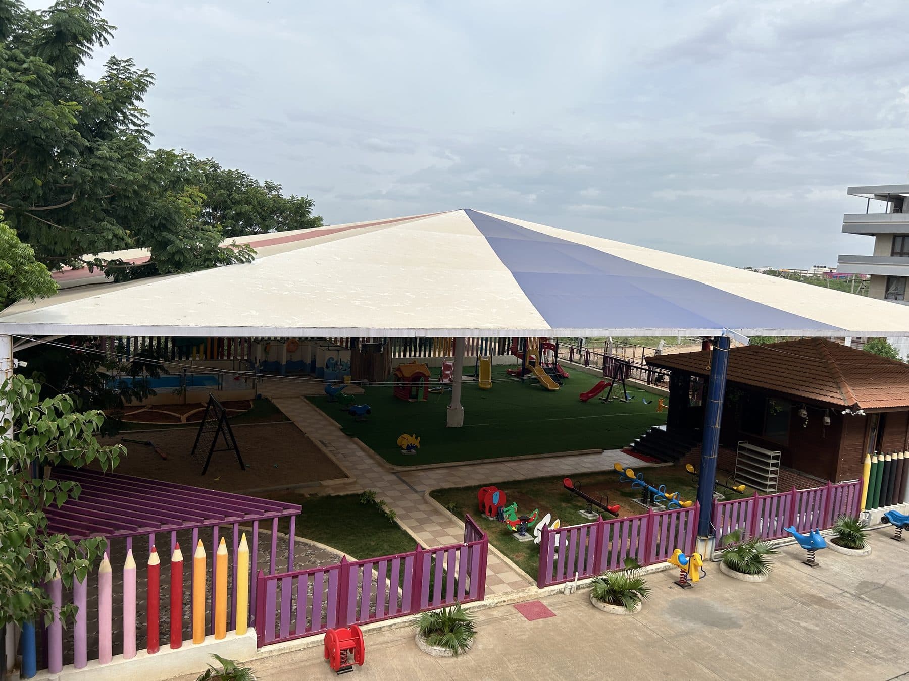 The play garden under its blue and white canopy