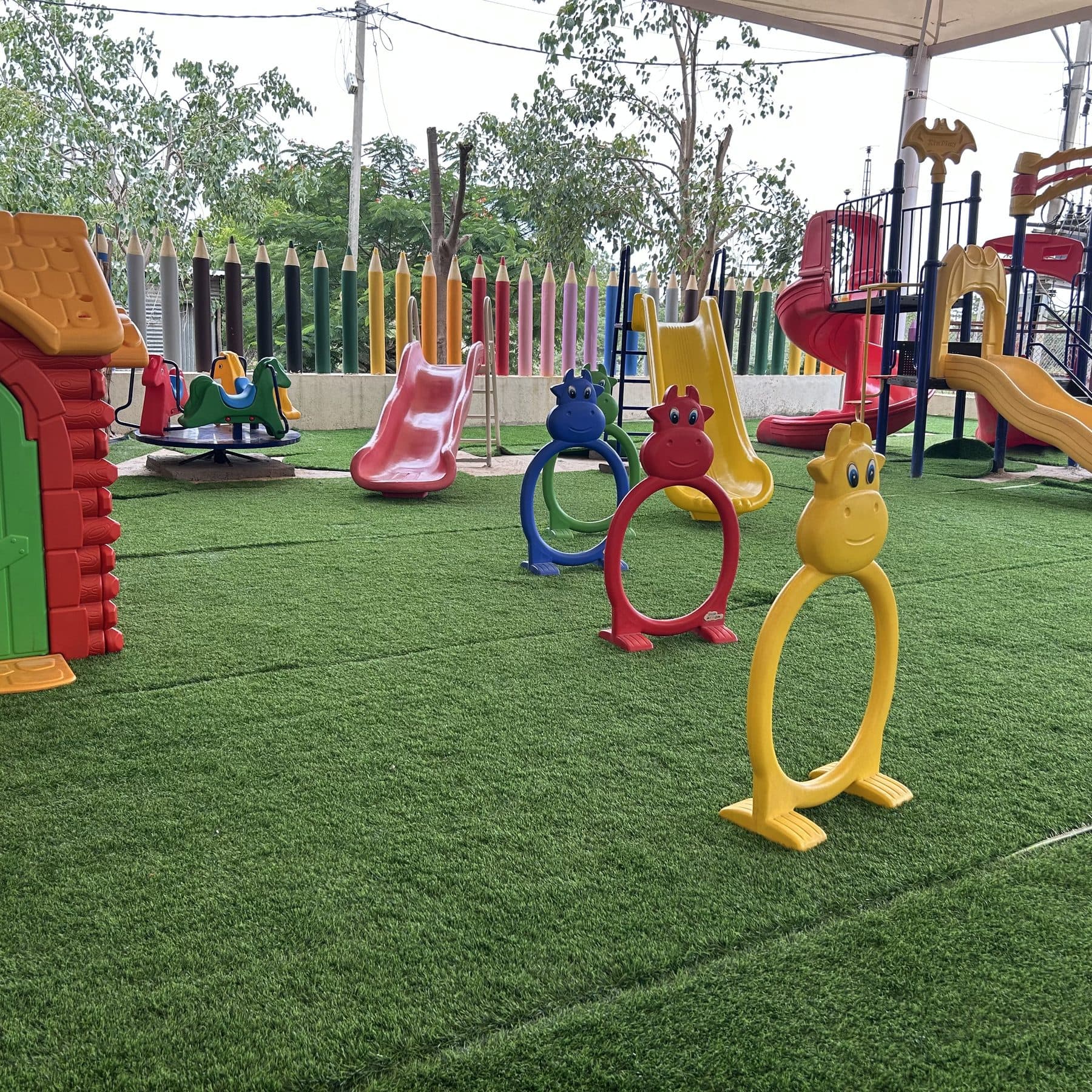 Colourful play equipment waiting on the green turf