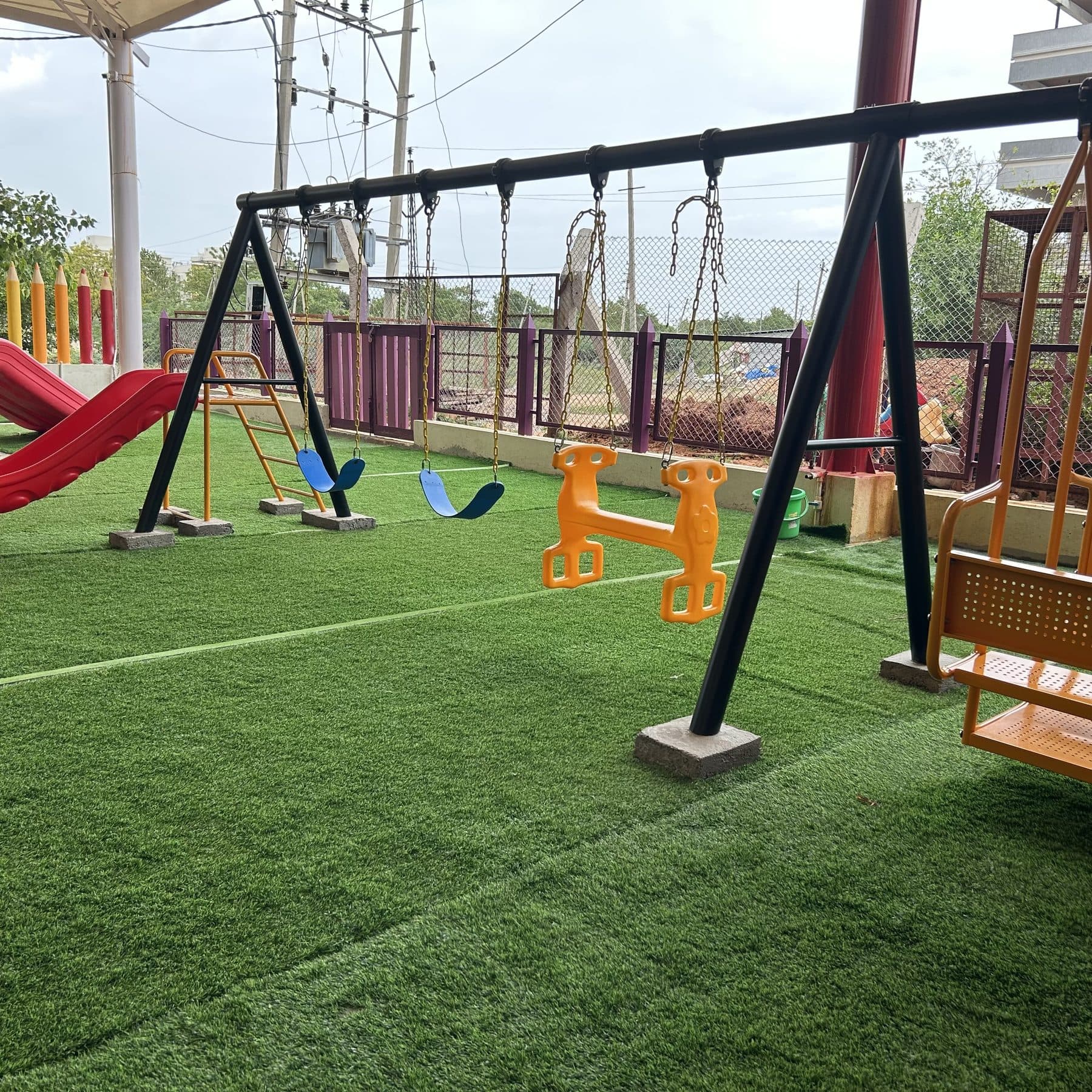 Swings and a slide in the outdoor play garden