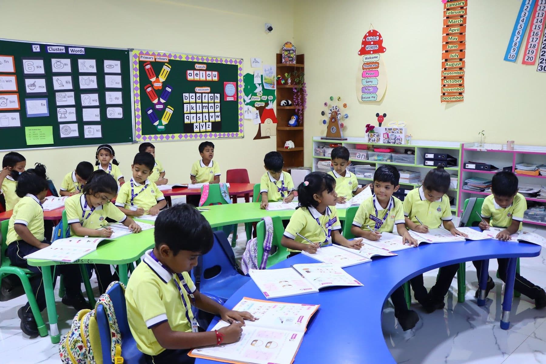 Children working at curved tables in a bright classroom