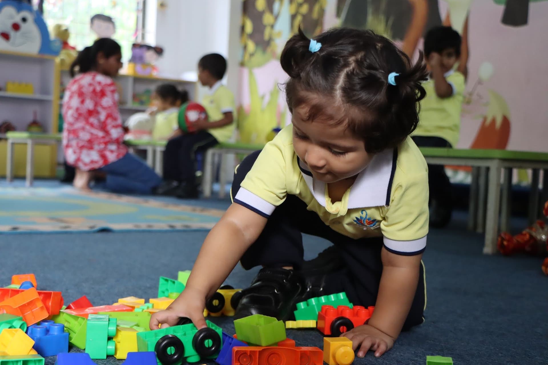 A toddler building with colourful blocks