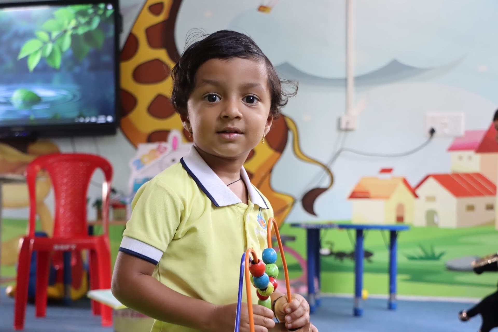 A child playing with a bead maze