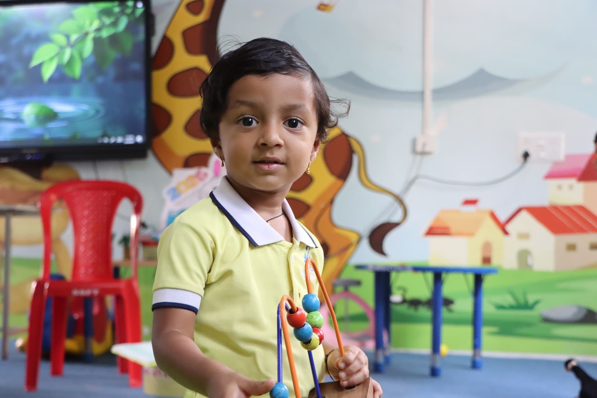 A child playing with a bead maze in the smart classroom