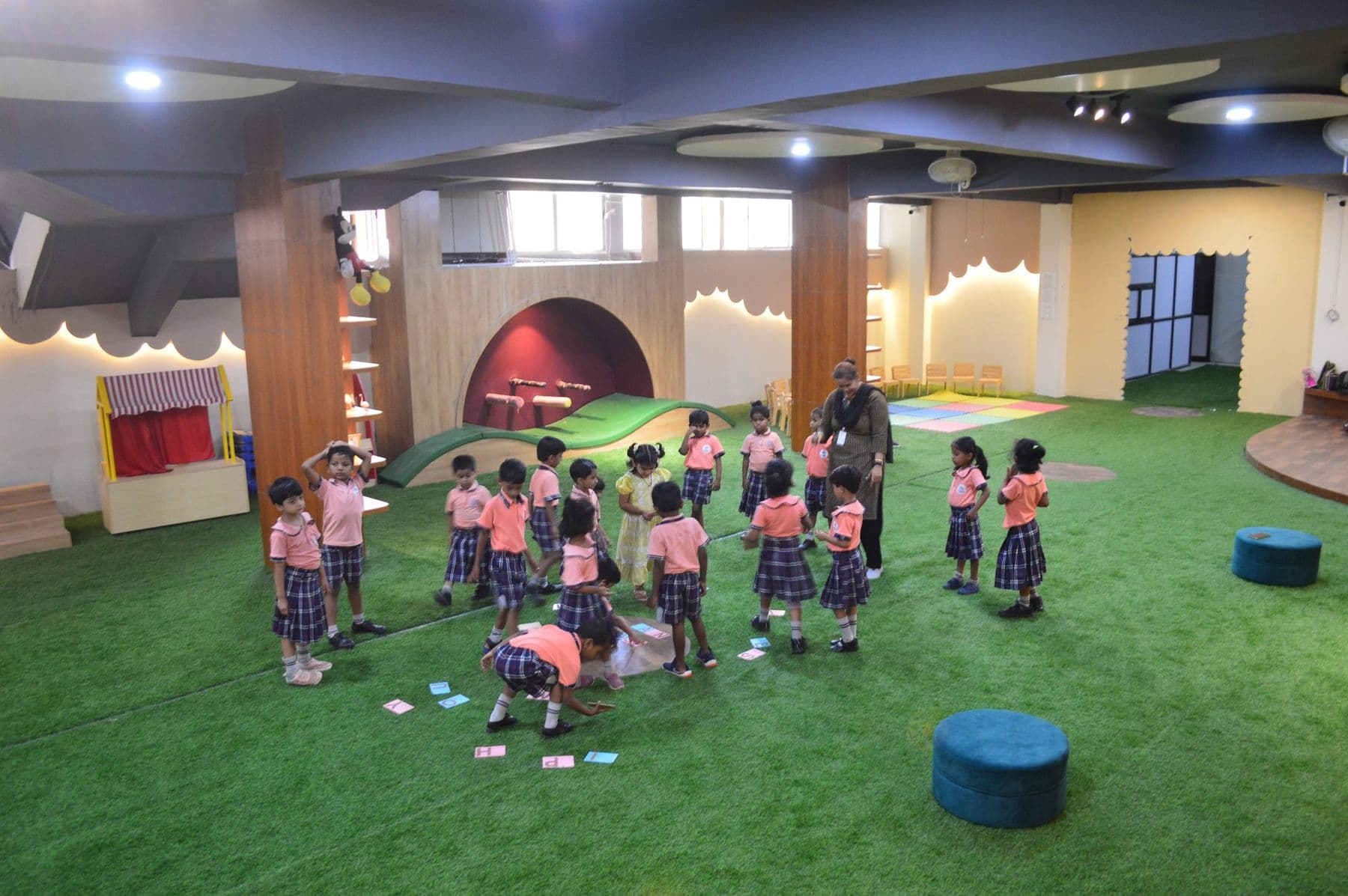 Children playing a game across the library hall