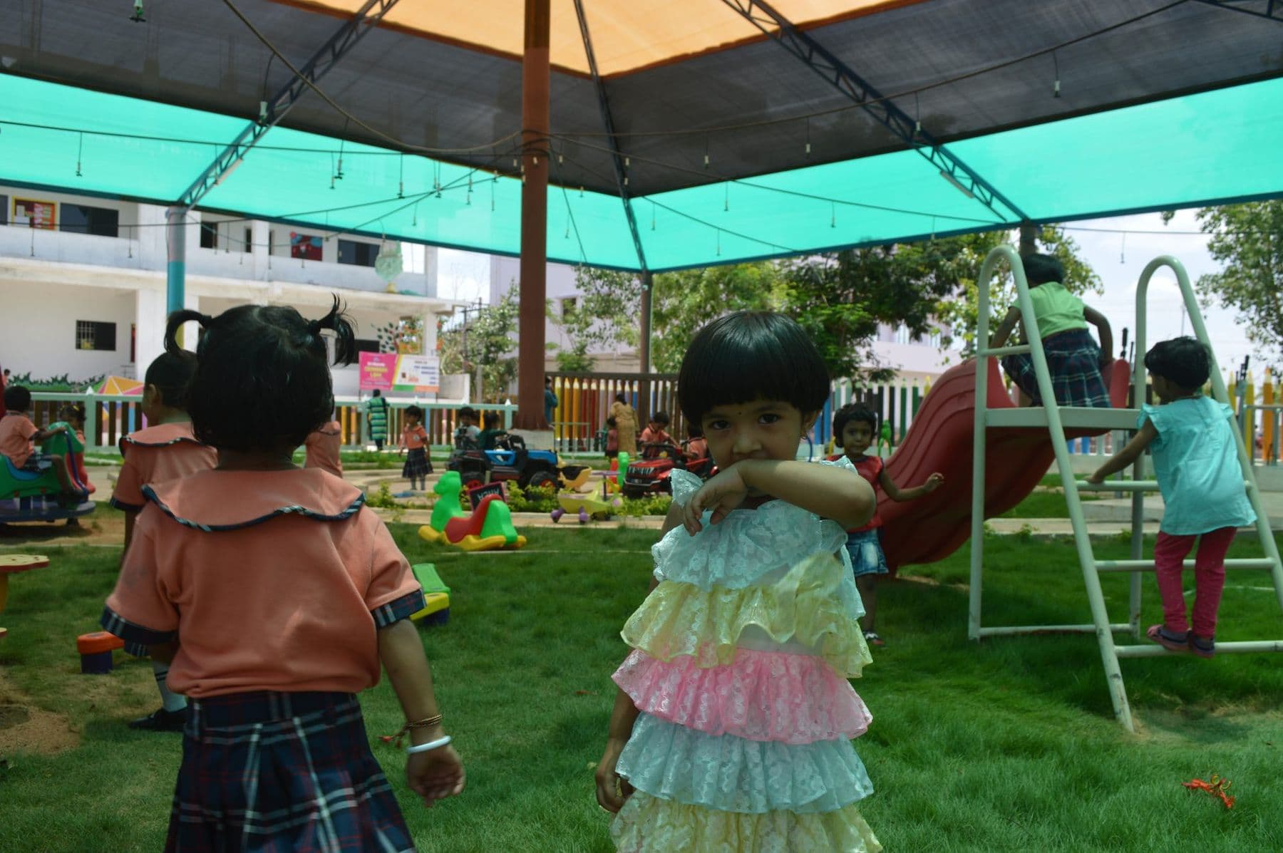 Two toddlers exploring the play garden