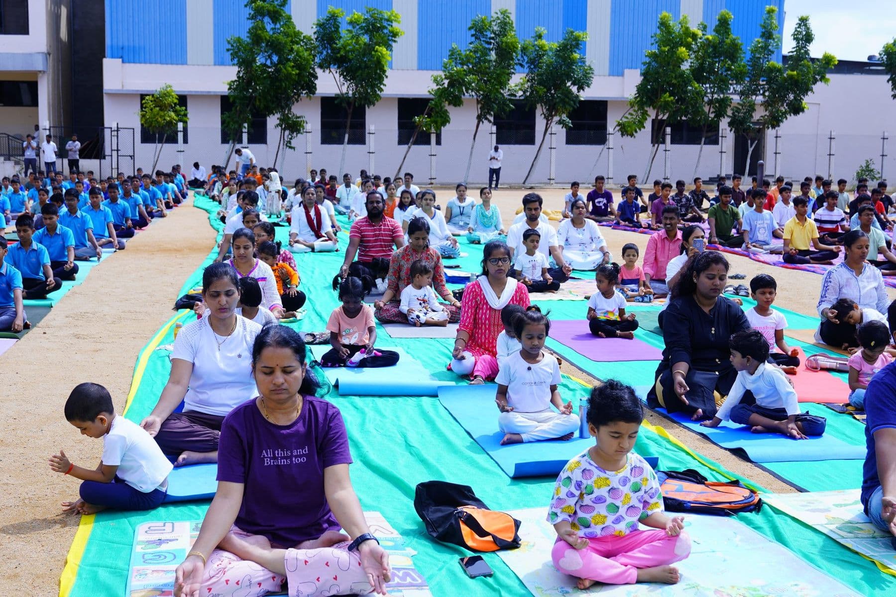 Families sitting cross-legged on yoga mats