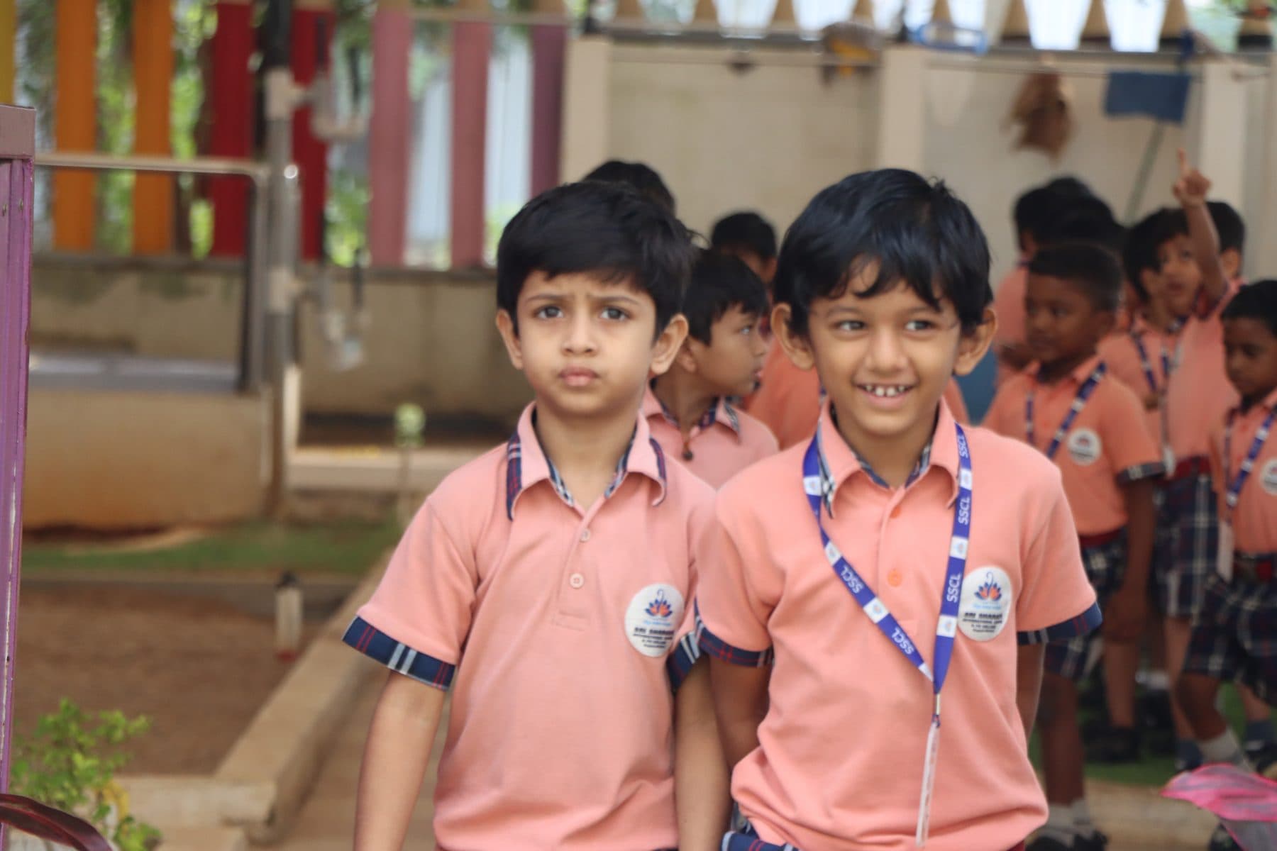 Two boys smiling as they line up with their friends