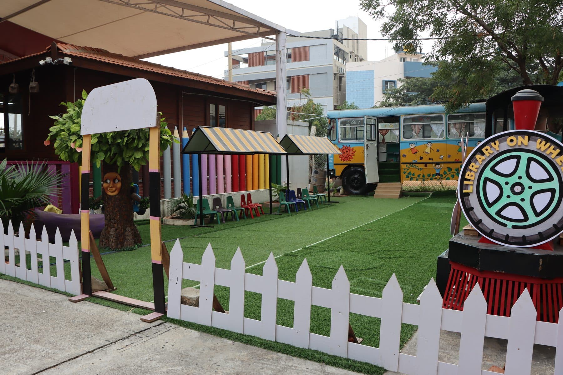 The Library on Wheels train and colourful huts in the garden