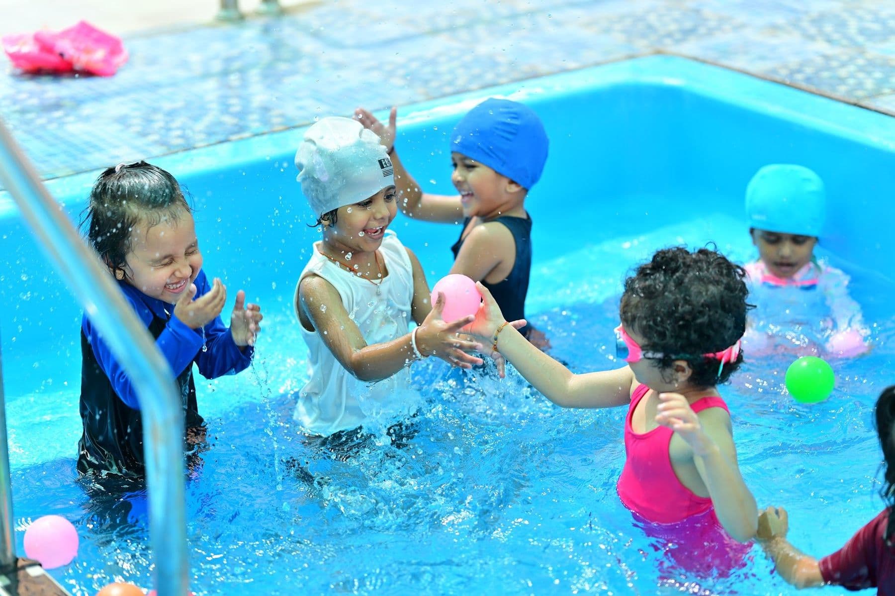 Children playing with balls in the pool