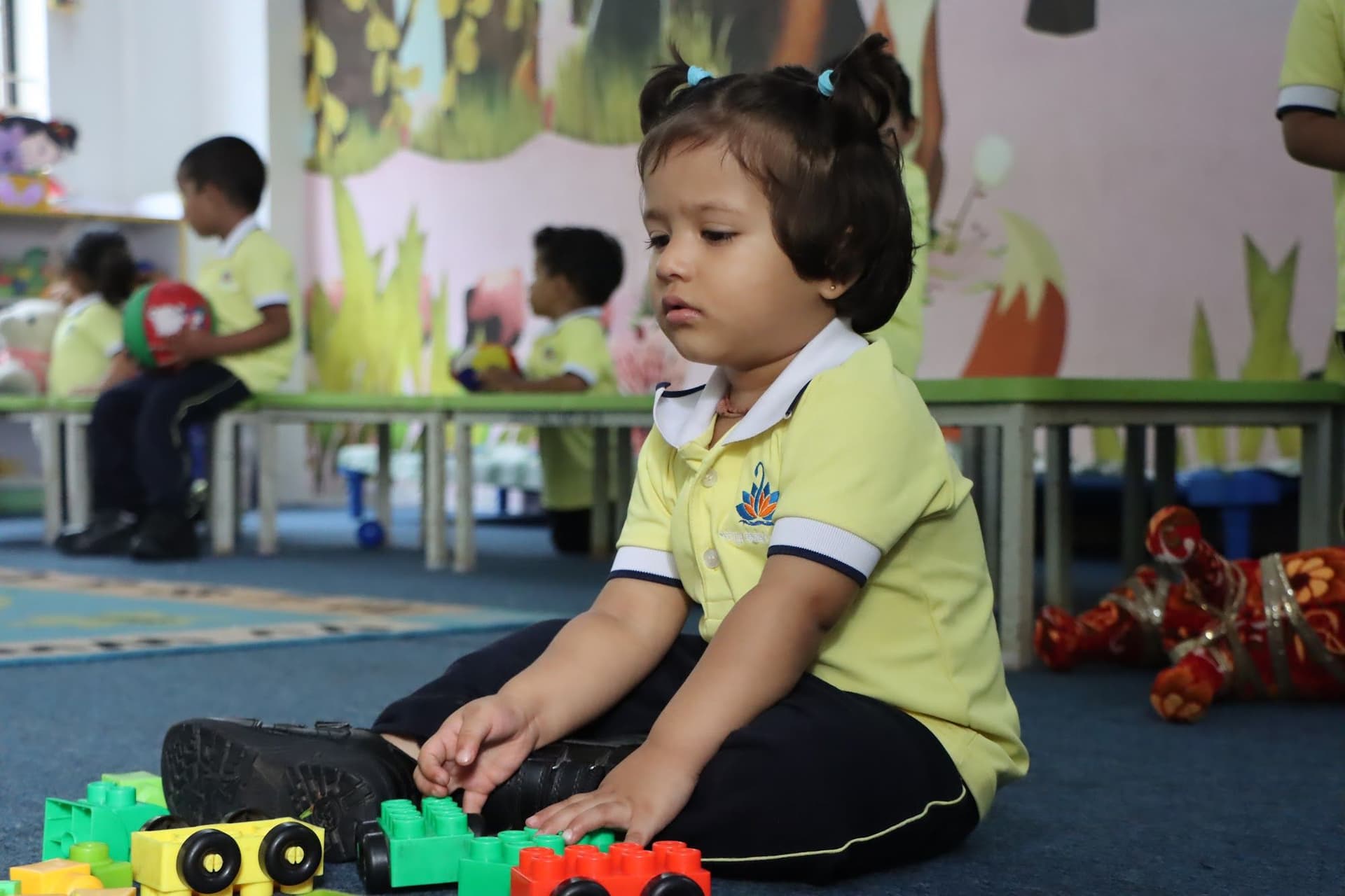 A toddler playing with building blocks